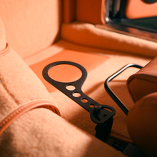 Universal no-drill cup holder mounted beside orange classic car seat