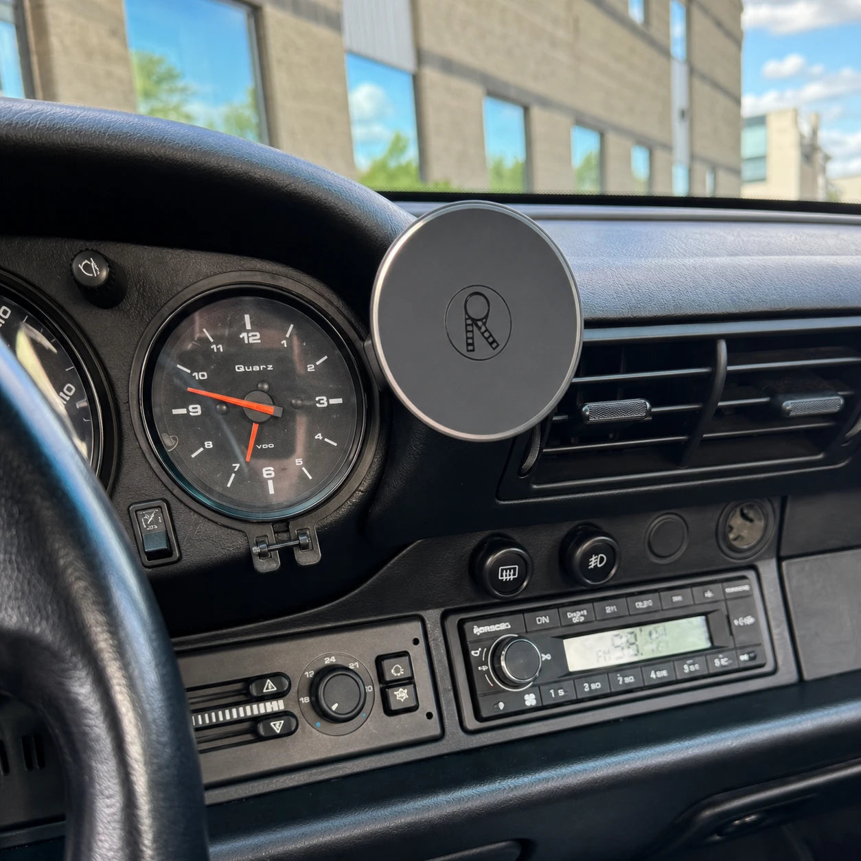 Rinashi 911 gauge phone mount installed beside the clock