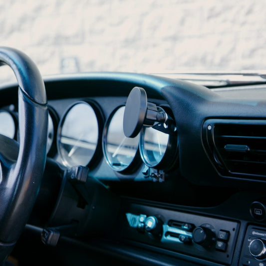 Rinashi Porsche 911 gauge phone mount installed on a vintage dashboard without a phone