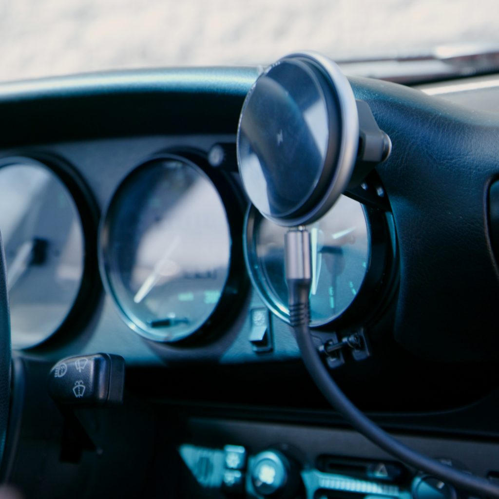 Porsche 911 phone holder with wireless charging cable routed below