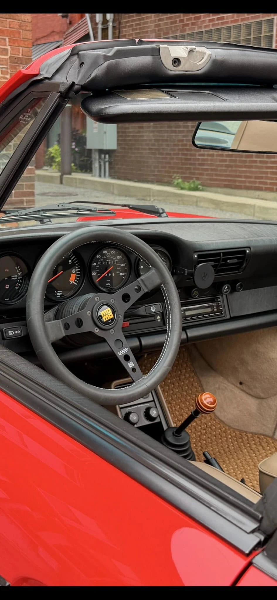 Red air-cooled Porsche 911 Targa interior with a Rinashi phone mount